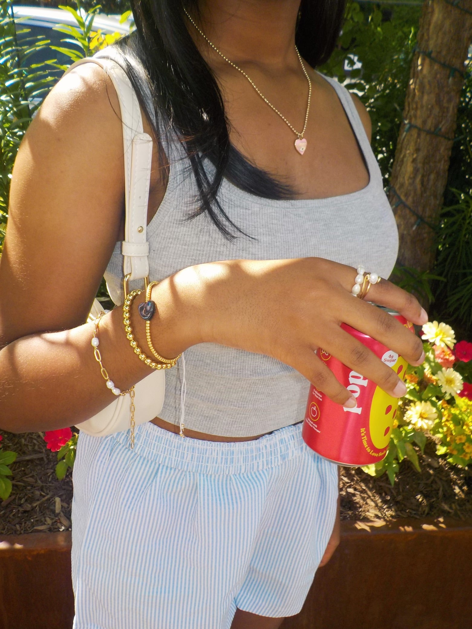 Girl Holding a Soda Can and Wearing Unique 18k Gold Plated Jewelry from MadeByZoe 